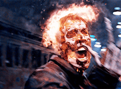 A Man With Flames Coming Out Of His Head Is Making A Funny Face GIF