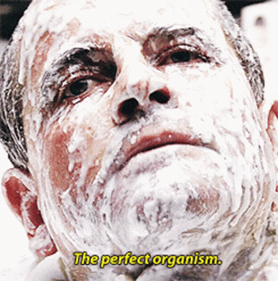 A Man With Foam On His Face And The Words " The Perfect Organism " Above Him GIF