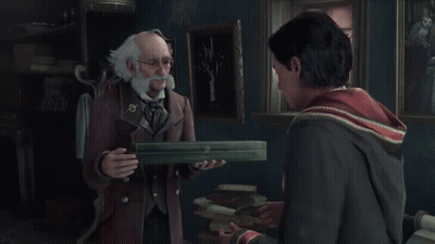 A Man With Glasses And A Badge With A Circle On It Is Reading A Book GIF