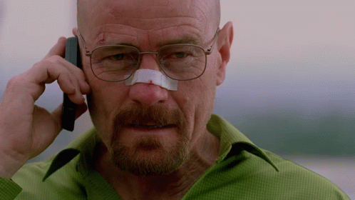 A Man With Glasses And A Bandage On His Nose Talks On A Cell Phone GIF