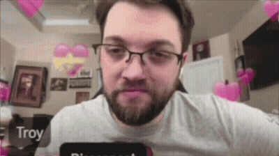 A Man With Glasses And A Beard Has Troy Written On His Phone Screen GIF