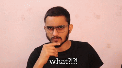 A Man With Glasses And A Beard Is Asking What GIF