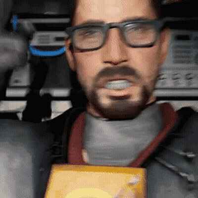 A Man With Glasses And A Beard Is Holding A Box In His Hand GIF