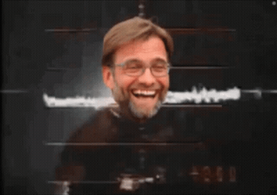 A Man With Glasses And A Beard Is Laughing GIF