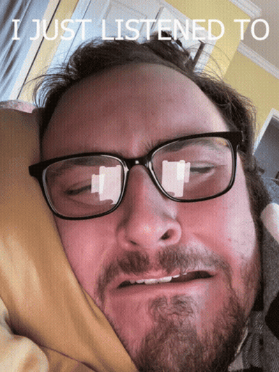 A Man With Glasses And A Beard Is Laying In Bed With The Words I Just Listened To Written Above Him GIF