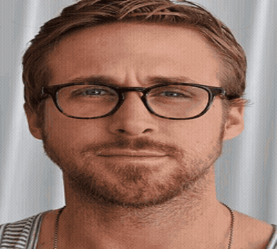 A Man With Glasses And A Beard Is Making A Face GIF