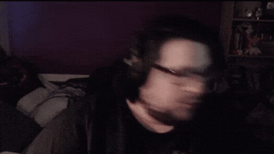 A Man With Glasses And A Beard Is Making A Face GIF