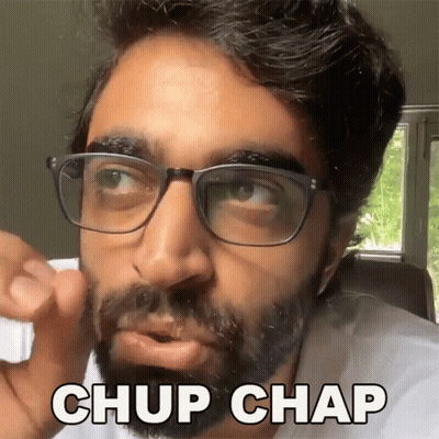 A Man With Glasses And A Beard Is Making A Funny Face And Saying Chup Chap GIF