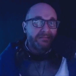 A Man With Glasses And A Beard Is Making A Funny Face And Saying Pass . GIF