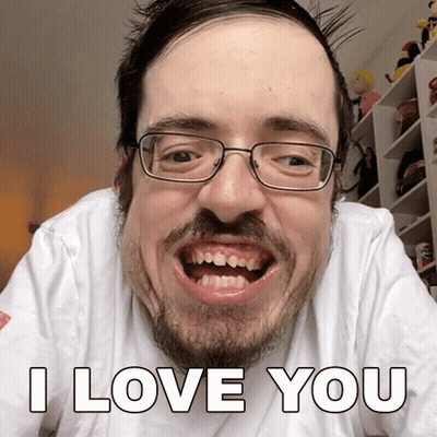 A Man With Glasses And A Beard Is Making A Funny Face And Says I Love You GIF