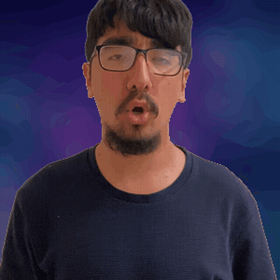 A Man With Glasses And A Beard Is Making A Surprised Face GIF
