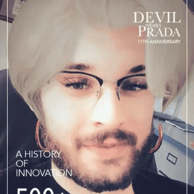 A Man With Glasses And A Beard Is On A Devil Wears Prada Poster GIF