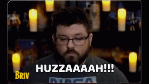 A Man With Glasses And A Beard Is Saying Huzzaaah !!! GIF