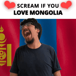 A Man With Glasses And A Beard Is Screaming In Front Of A Mongolia Flag GIF