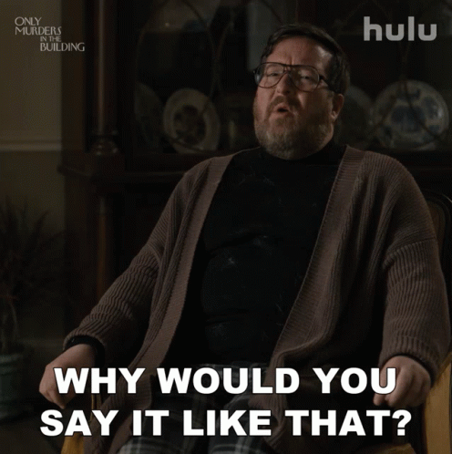 A Man With Glasses And A Beard Is Sitting In A Chair And Says " Why Would You Say It Like That " GIF