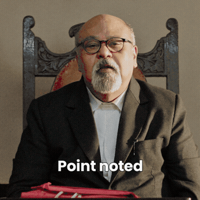 A Man With Glasses And A Beard Is Sitting In A Chair With The Word Point Noted Written Below Him GIF