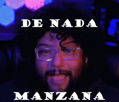 A Man With Glasses And A Beard Is Sitting In A Chair With The Words De Nada Manzana Above Him GIF