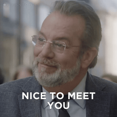 A Man With Glasses And A Beard Is Smiling And Says Nice To Meet You GIF