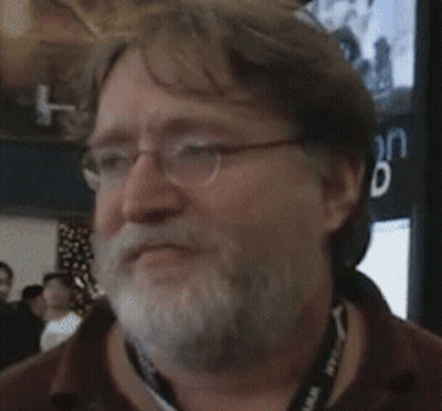 A Man With Glasses And A Beard Is Smiling In Front Of A Sign That Says " Vation Eiled " GIF