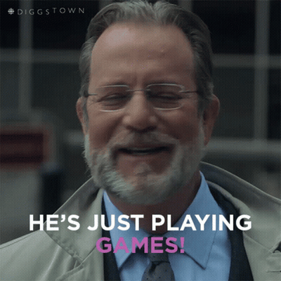 A Man With Glasses And A Beard Is Smiling With The Words He 'S Just Playing Games Below Him GIF