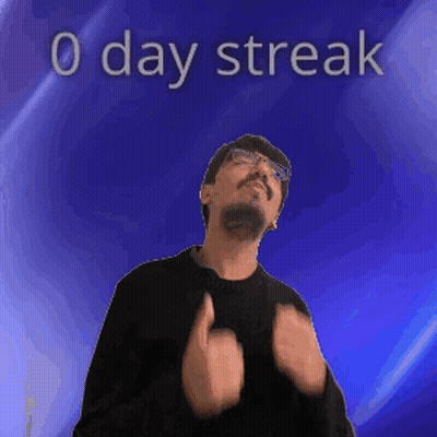 A Man With Glasses And A Beard Is Standing In Front Of A Blue Background With The Words 0 Day Streak On It GIF