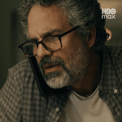 A Man With Glasses And A Beard Is Talking On A Cell Phone With The Caption Yeah It 'S Him GIF