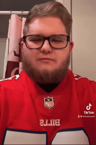 A Man With Glasses And A Beard Is Wearing A Buffalo Bills Shirt GIF