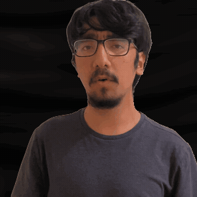 A Man With Glasses And A Beard Is Wearing A Gray Shirt GIF
