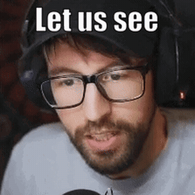 A Man With Glasses And A Beard Is Wearing A Hat And Headphones And Says `` Let Us See '' . GIF