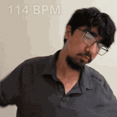 A Man With Glasses And A Beard Is Wearing A Shirt That Says 114 Bpm On It GIF