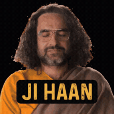 A Man With Glasses And A Beard Is Wearing A Yellow Shirt And A Black Sign That Says Ji Haan GIF