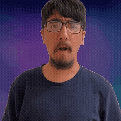 A Man With Glasses And A Beard Looks At The Camera GIF