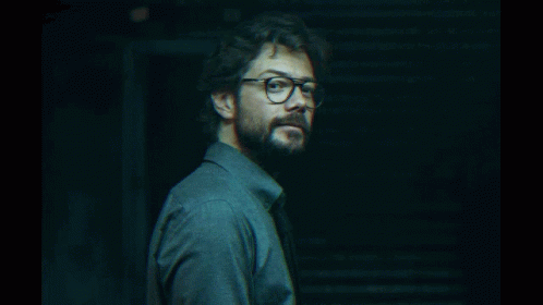 A Man With Glasses And A Beard Looks To The Side GIF