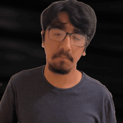 A Man With Glasses And A Beard Looks Up GIF