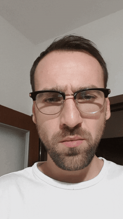 A Man With Glasses And A Beard Makes A Face GIF