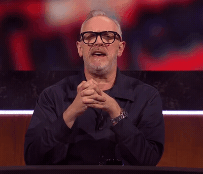 A Man With Glasses And A Beard Making A Devil Horns Gesture GIF