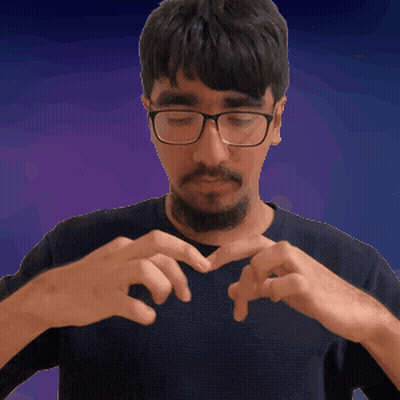 A Man With Glasses And A Beard Making A Heart With His Hands GIF