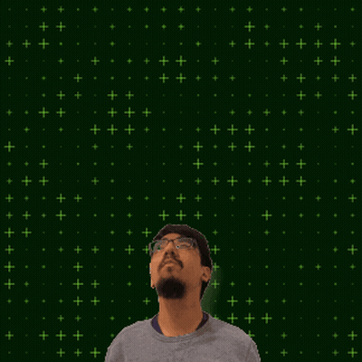 A Man With Glasses And A Beard Stands In Front Of A Green Background With 9 + 8 Written On It GIF