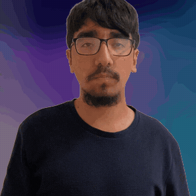 A Man With Glasses And A Beard Wearing A Black Shirt GIF