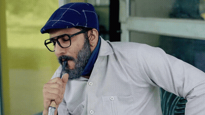 A Man With Glasses And A Beard Wearing A Blue Hat GIF