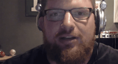 A Man With Glasses And A Beard Wearing Headphones GIF