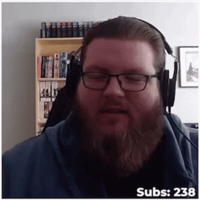 A Man With Glasses And A Beard Wearing Headphones With The Number 238 On The Bottom Right GIF