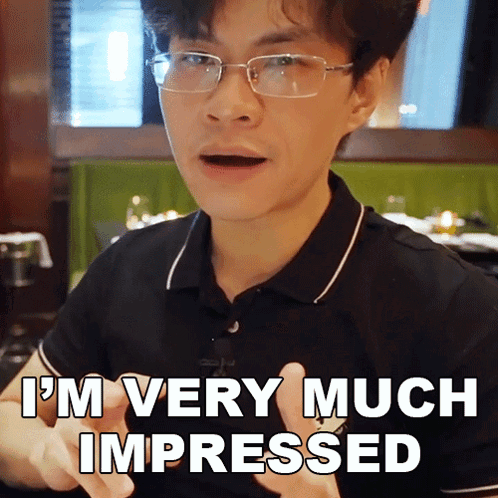 A Man With Glasses And A Black Shirt Says I 'M Very Much Impressed GIF
