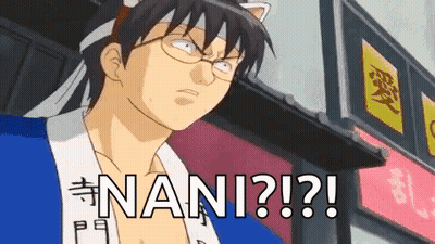 A Man With Glasses And A Cat Ear Headband Is Standing In Front Of A Building With The Word Nani Written On It . GIF