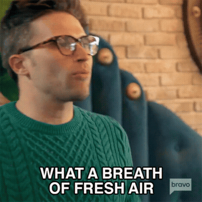 A Man With Glasses And A Green Sweater Says What A Breath Of Fresh Air GIF