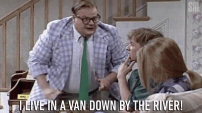A Man With Glasses And A Green Tie Says " I Live In A Van Down By The River " While Talking To Two People GIF