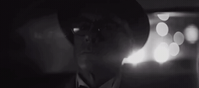 A Man With Glasses And A Hat Is Looking At The Camera GIF