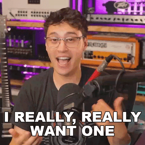 A Man With Glasses And A Microphone Says " Really Really Want One " GIF