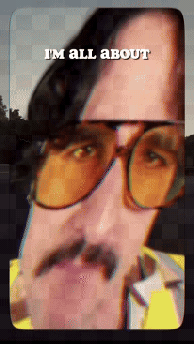 A Man With Glasses And A Mustache Has The Words I 'M All About Above His Head GIF
