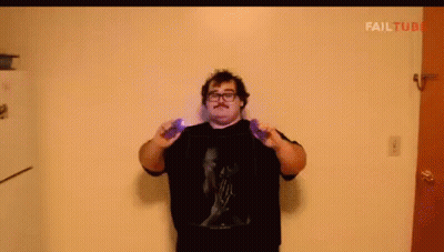 A Man With Glasses And A Mustache Is Holding A Purple Object In Front Of A Wall With Failtube Written On It GIF
